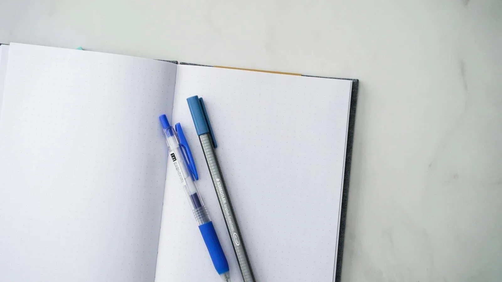 Open notebook with pen representing